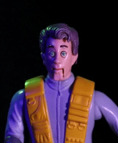 An action figure shaking, making a scared face with its eyes popping out of its head. 