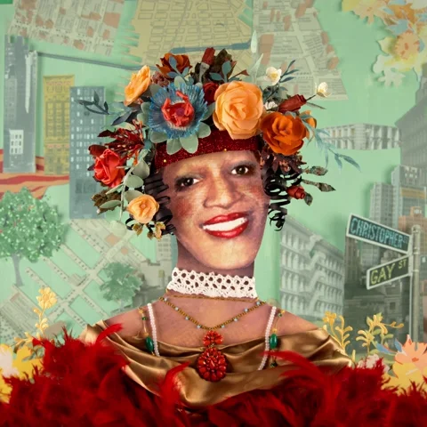 An animation of Marsha P Johnson. She is wearing colorful flowers on her head and images of New York City are behind her. 