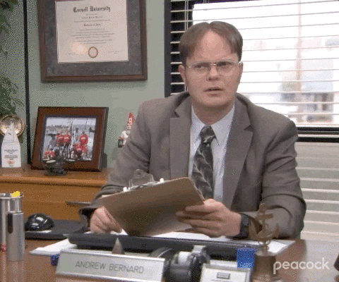 Dwight from The Office with a clipboard wondering something