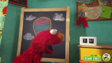 Elmo is behind a chalkboard, dresser, and alarm clock. He turns around and says, 