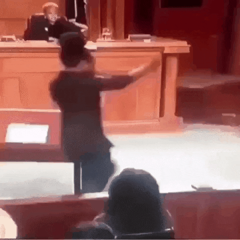 A person dancing in front of a judge in court