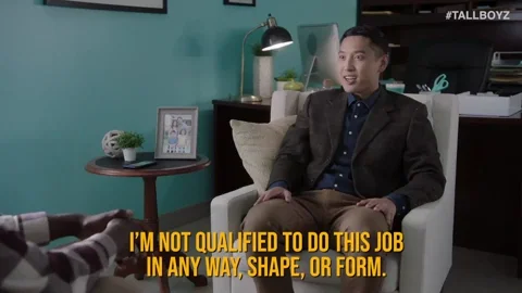 GIF: Man in suit jacket sitting in therapy or work office says, 'I'm not qualified to do this job in any way shape, or form.'
