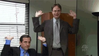 Dwight and Michael from The Office, joyfully celebrating by raising their arms in excitement.