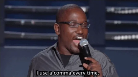 Hannibal Buress on stage during a stand-up comedy show. He says, 'I use a comma every time.'