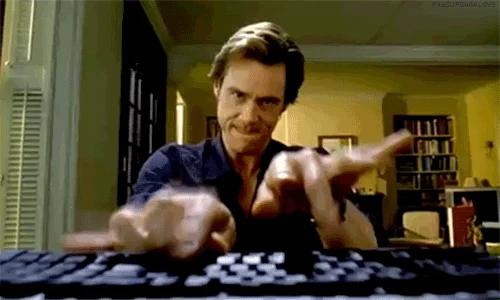 Jim Carrey typing quickly on a keyboard.