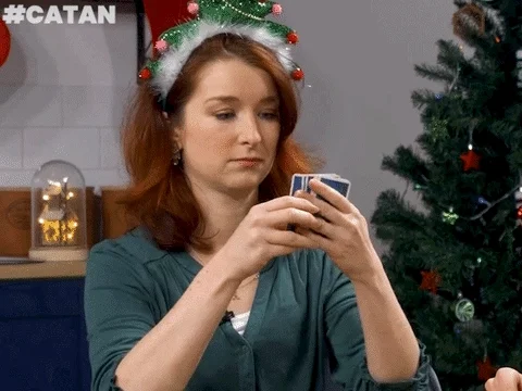A woman counting cards at Christmas party.