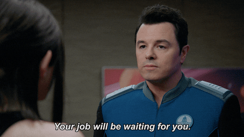 Actor Seth MacFarlane is standing in front of a woman, saying 'Your job will be waiting for you.'