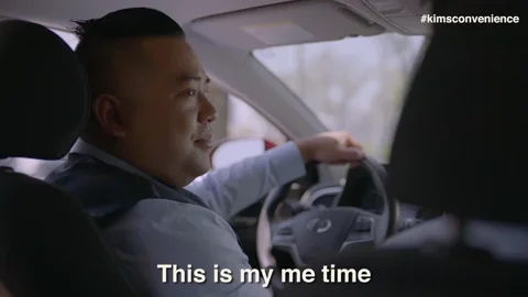 A man sitting in a car while telling the passenger, 'This is my me time, Things get real.'