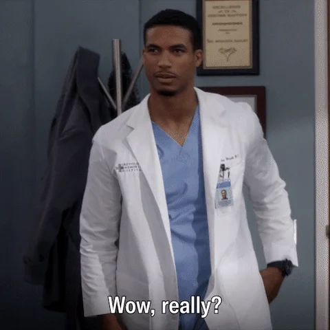A man in a white coat in a hospital setting saying, 