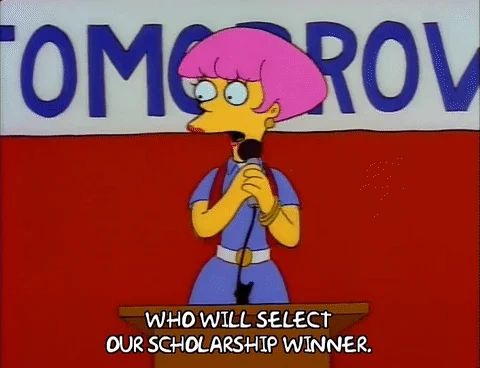A character from the Simpsons asks 'who will select our scholarship winner' while on stage.