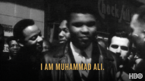 Muhammad Ali introducing himself to news reporters during a protest.