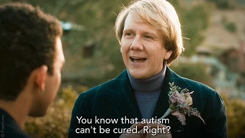 A man with blond hair and wearing a green blazer saying, 'You know that autism can't be cured. Right?'