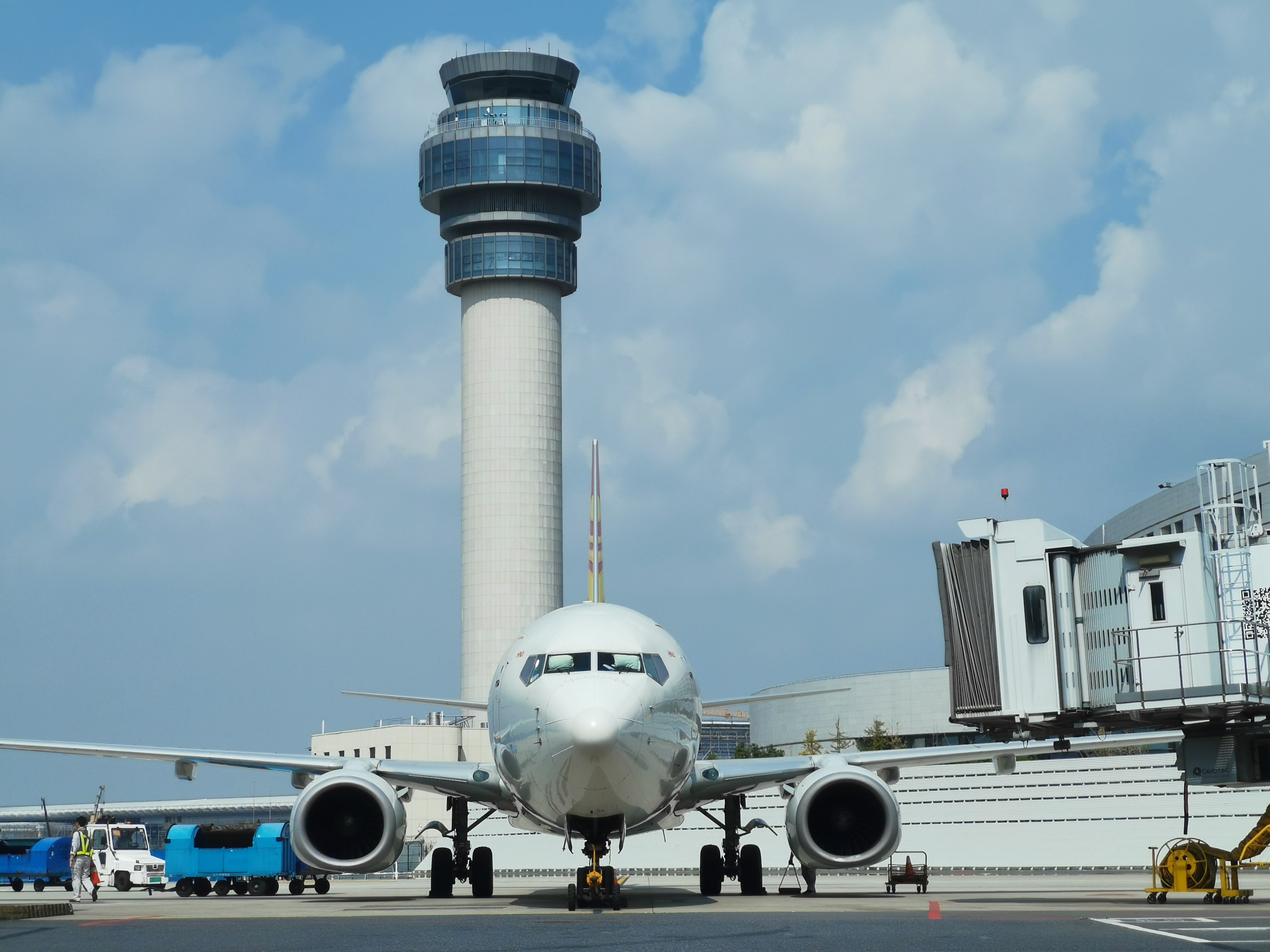 Airplane on a tarmac in front of a lookout tower