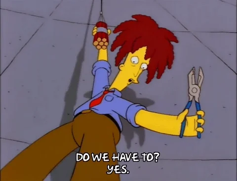 Sideshow Bob from The Simpsons hangs from a rope connected to dynamite. He holds clippers and says, 