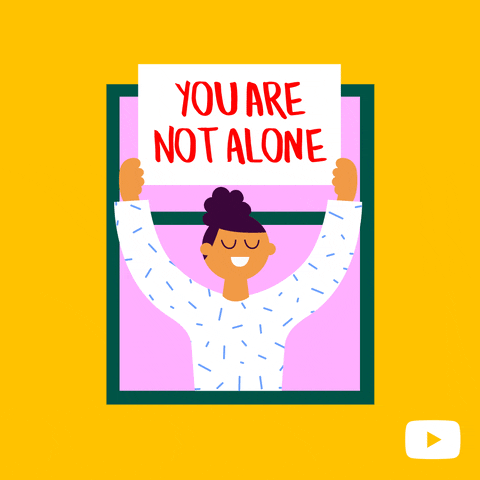 Cartoon holding a 'you are not alone' poster