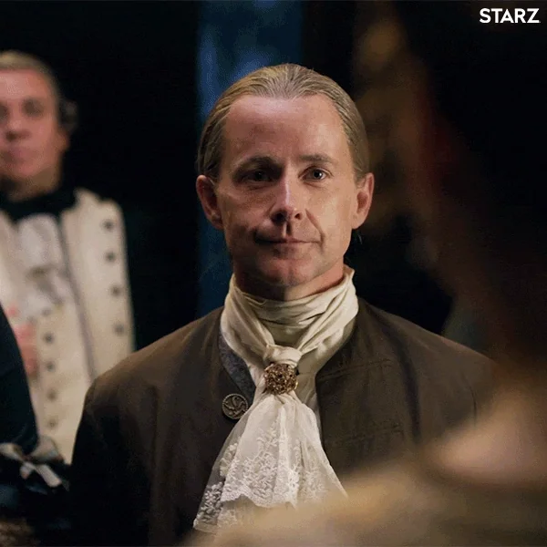 Two people in a royal court formally greet each other with a bow and curtsy.