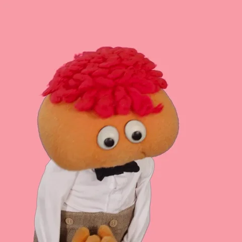 A puppet wearing a bowtie says, 