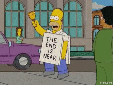 Homer Simpson walks down the street with a sign that reads 