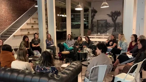 A group of Italian language learners meeting at an event space.