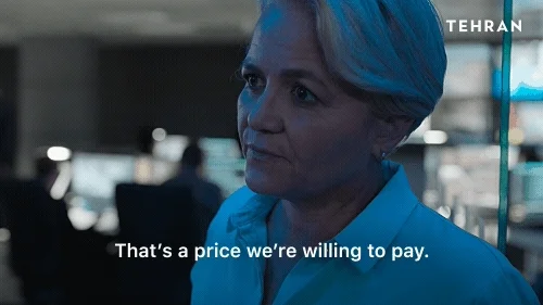 A woman in office attire saying, 'That's a price we're willing to pay.'