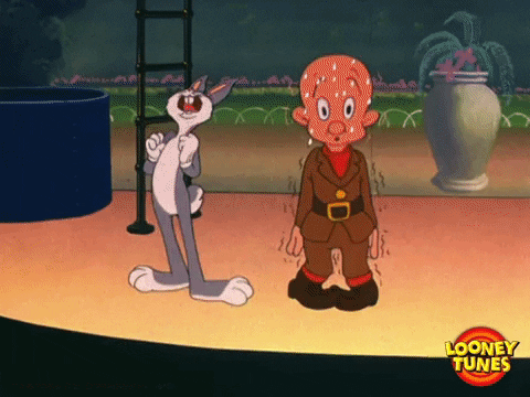Elmer Fudd and Bugs Bunny on a stage. Elmer looks nervous about public speaking.