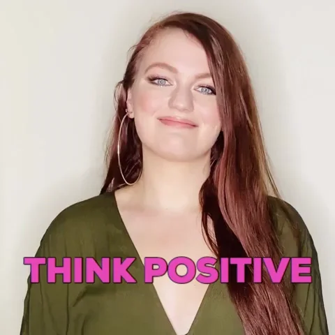 A woman saying, 'think positive'