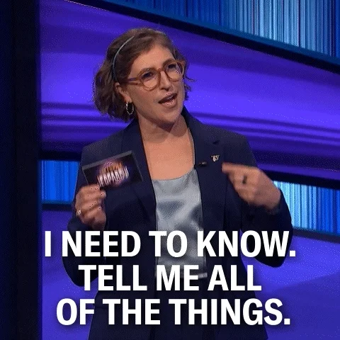 Mayim Bialik showing a hand gesture with text saying 'I need to know. Tell me all of the things.'