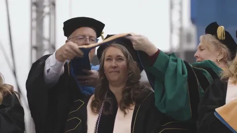 A highlight reel of a diverse group of graduates receiving their diplomas at a ceremony.