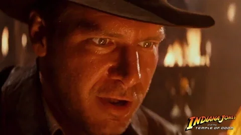Indiana Jones looking at a treasure in awe.