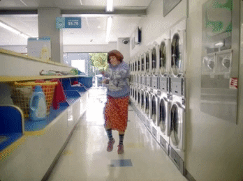 Lady dancing in laundromat