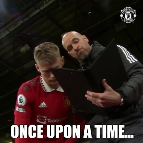 A soccer coach reads a playbook to one of his players. The text reads, "Once upon a time..."