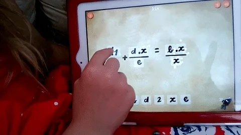 A child uses a math app on an ipad to complete algebra equations.