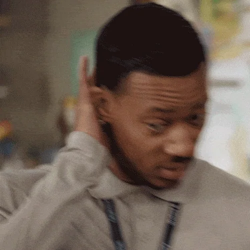 A man looks up nervously while brushing his hand across his neck.