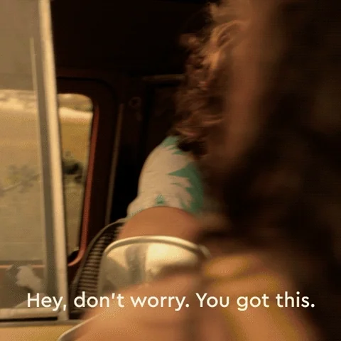 A man with shaggy brown hair in a green Hawaiian shirt leans out of a car. He says, 