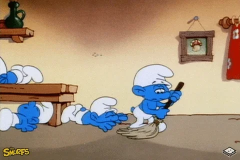 A Smurf sweeping the floor