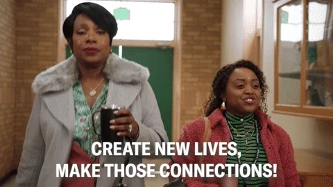 2 teachers, walking down school hall, captioned - create new lives, make those connections!
