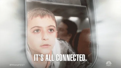 A young boy with light skin, brown hair and hazel eyes looking out a plane window. He says, 