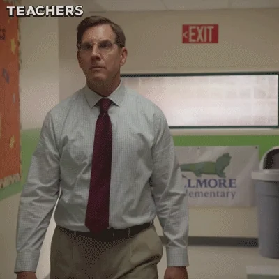 A teacher in a school who sees a student and starts running away.