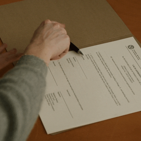 A person is signing an agreement.