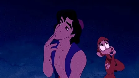 Aladdin talks to a monkey. They both gesture that they have a great idea.