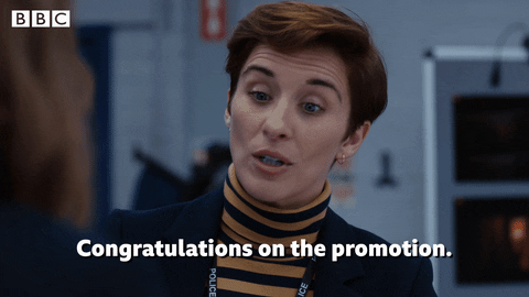 A woman in an office saying, 'Congratulations on the promotion.'