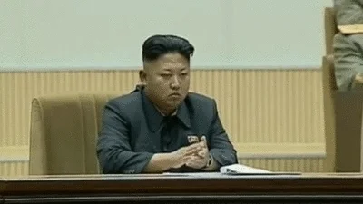Kim Jong Un clapping at a meeting.