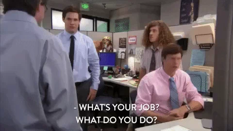 The main characters of Workaholics in a cubicle. One of them asks a colleague, 