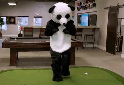 person in a panda costume dancing at home