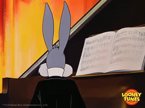 Bugs Bunny (from Looney Tunes) siting at a piano. He looks back and grins.