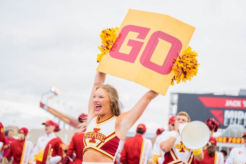 A cheerleader holding a sign that says 