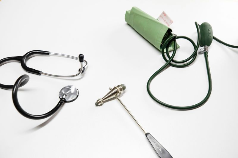 Image of doctor's instruments - stethoscope, knee reflex hammer, and a blood pressure monitor