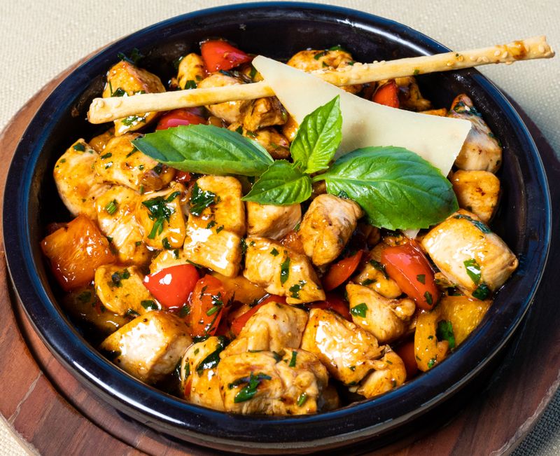 A healthy chicken dish with vegetables and fresh herbs.