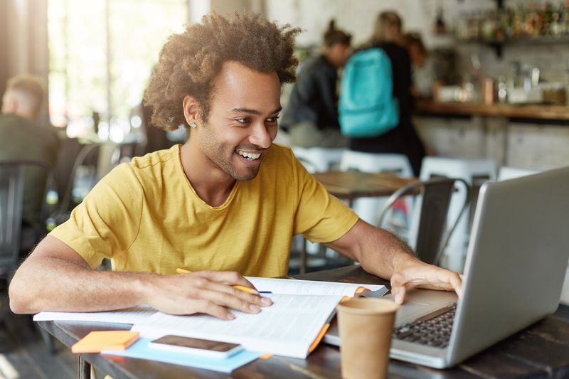 A student looking happy while studying after using the Eisenhower Matrix.