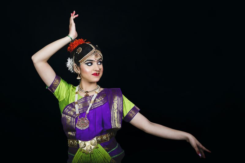 A female Indian dancer poses in traditional costume.